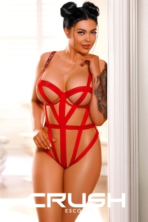 Melody South Kensington escort is posing sexy in red lingerie.